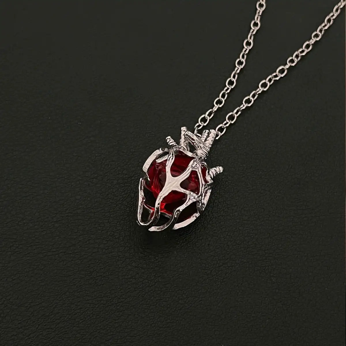 Soul Resonance Gothic Heart Necklace featuring a vintage red glass heart wrapped in intricate filigree.