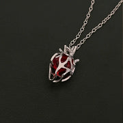 Soul Resonance Gothic Heart Necklace featuring a vintage red glass heart wrapped in intricate filigree.