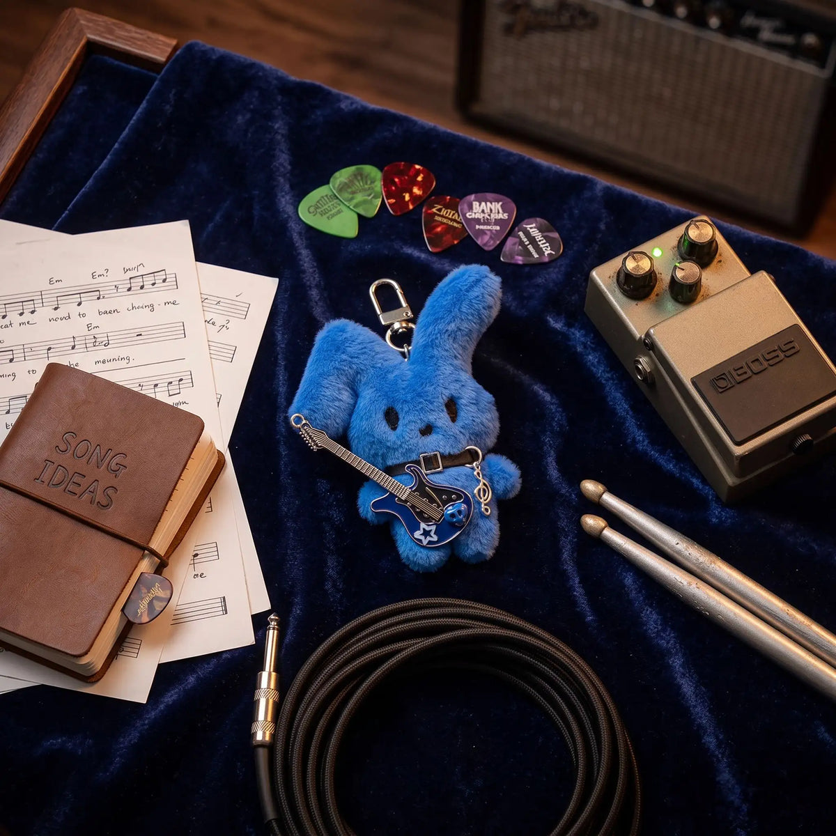 Guitarist Bunny Plush Charm featuring a blue mochi rabbit with a guitar, surrounded by music items.
