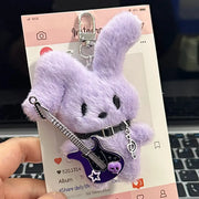 Guitarist Bunny Plush Charm featuring a cute purple bunny holding a plush guitar, ideal for backpacks.