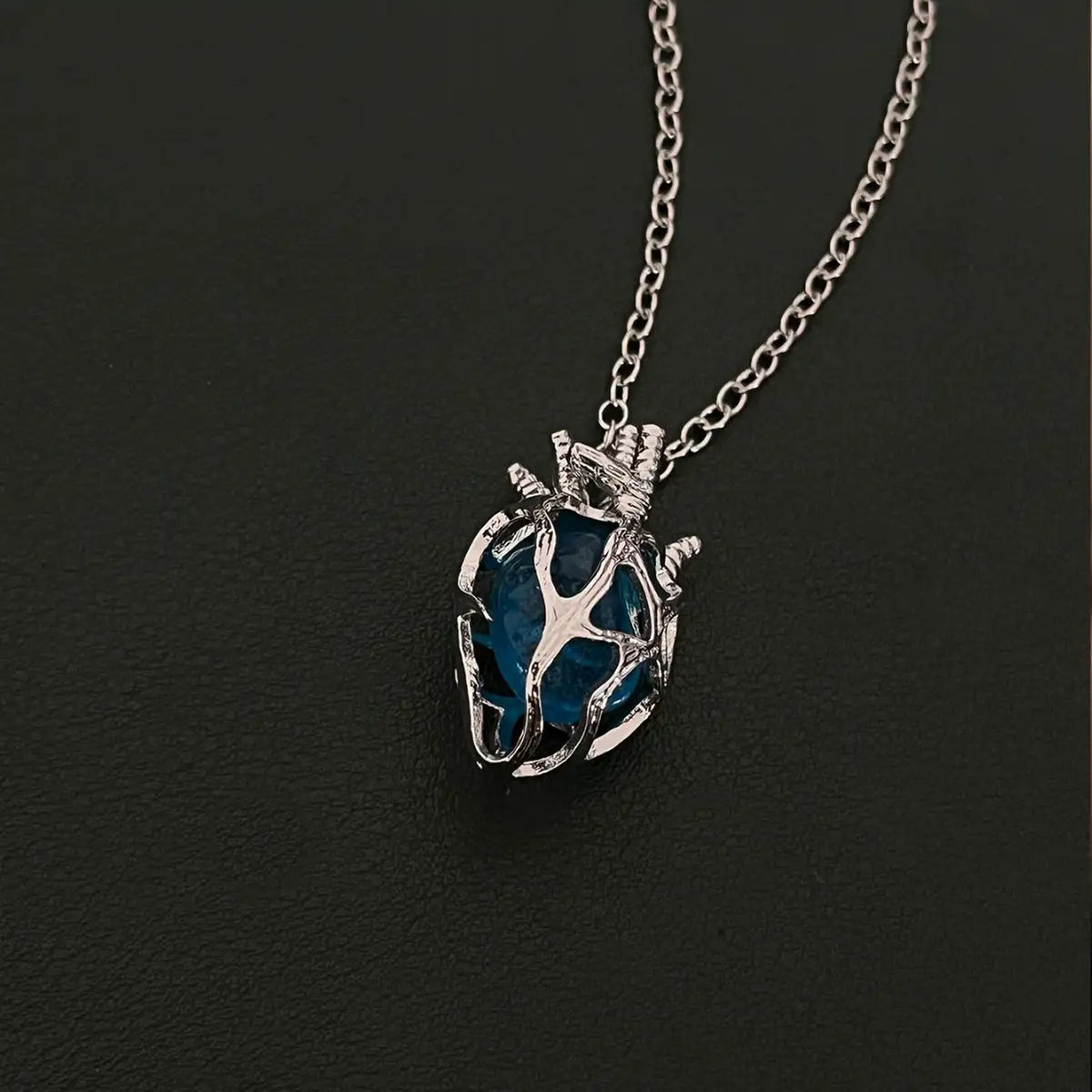 Soul Resonance Gothic Heart Necklace featuring a blue glass heart in vintage-gothic filigree design.