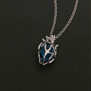 Soul Resonance Gothic Heart Necklace featuring a blue glass heart in vintage-gothic filigree design.