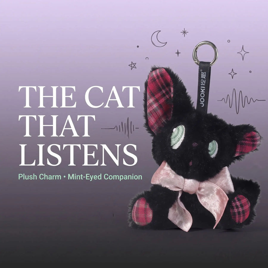 Listening black cat plush toy - a cute plush charm with mint-green eyes and a pink bow.