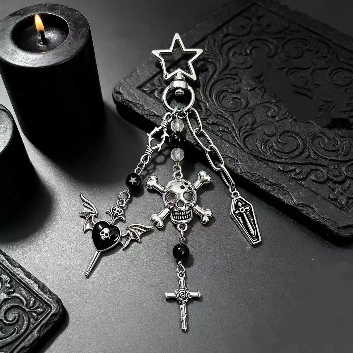 Gothic Skull and Cross Bag Charm featuring skull, cross, and bat designs on a dark, textured background.