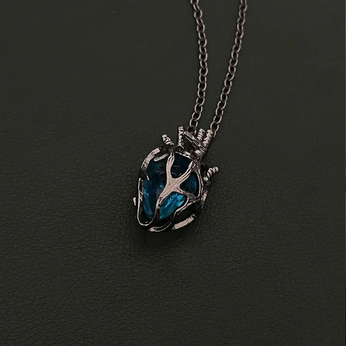 Soul Resonance Gothic Heart Necklace featuring a blue glass core wrapped in vintage filigree design.