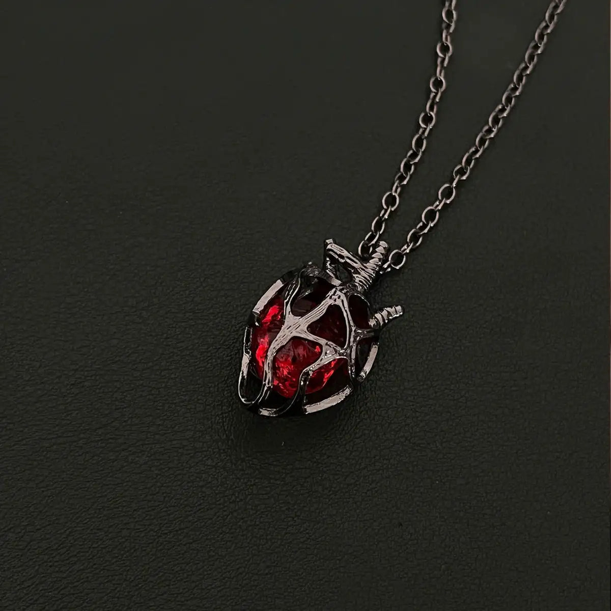 Soul Resonance Gothic Heart Necklace featuring a vintage-style heart with a red glass core and intricate filigree design.