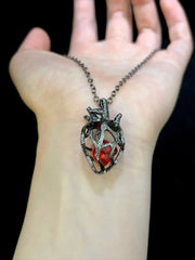 Soul Resonance Gothic Heart Necklace featuring a vintage-style pendant with a red glass core.