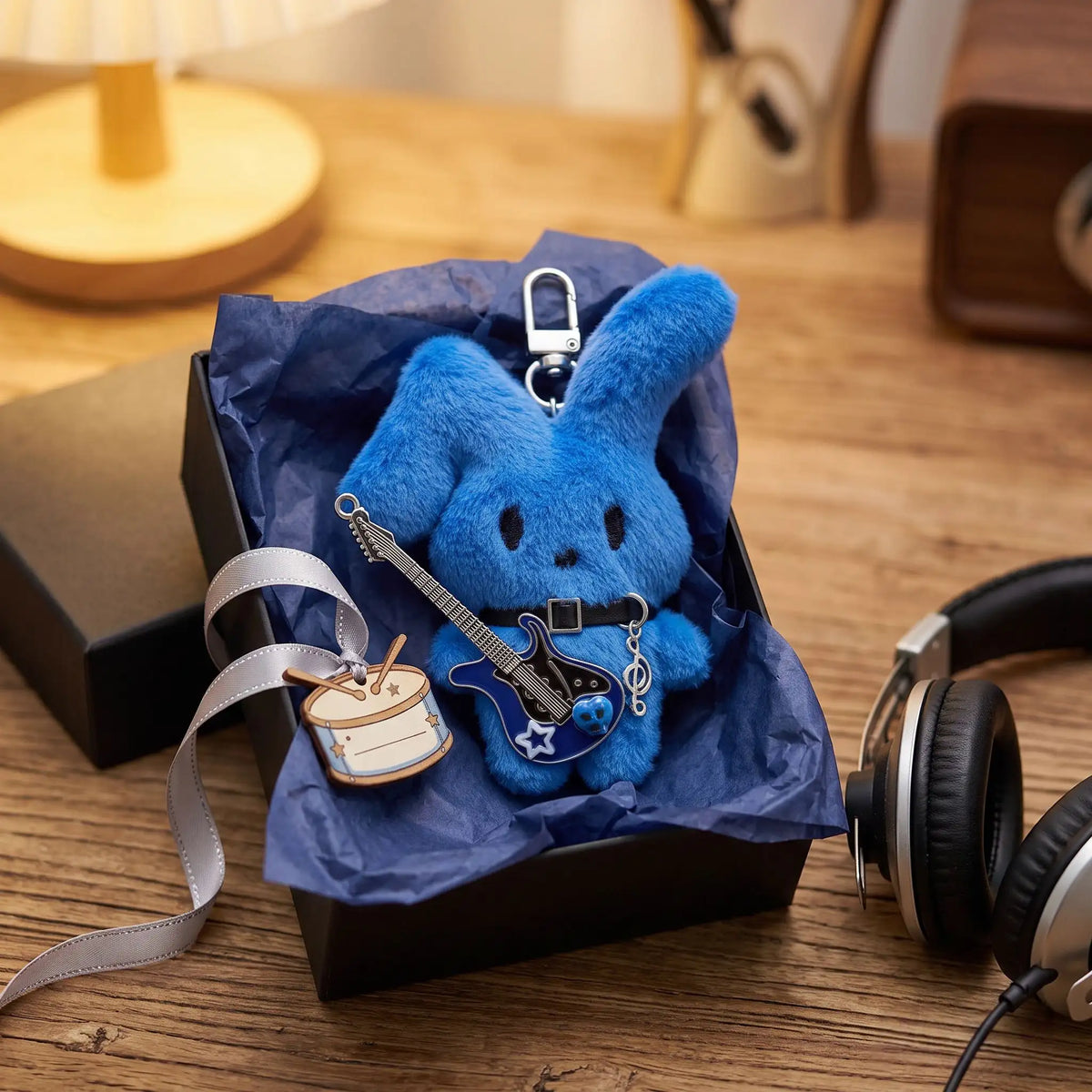 Guitarist Bunny Plush Charm in a gift box featuring a blue mochi rabbit holding a plush guitar accessory.