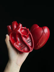 Vintage Heart Trinket Box held in hand, showcasing sculpted red anatomical heart with text inscribed inside.