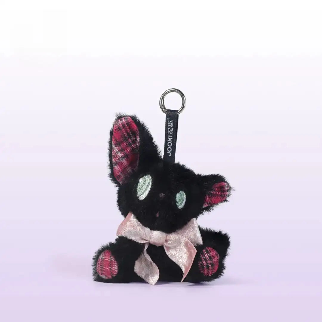 Listening black cat plush toy with green eyes and pink bow, perfect as a charming gift.