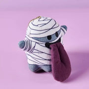 Monster Crew Plush Bag Charm featuring a cute mummy design with sleepy eyes and a purple tongue, perfect for Halloween.