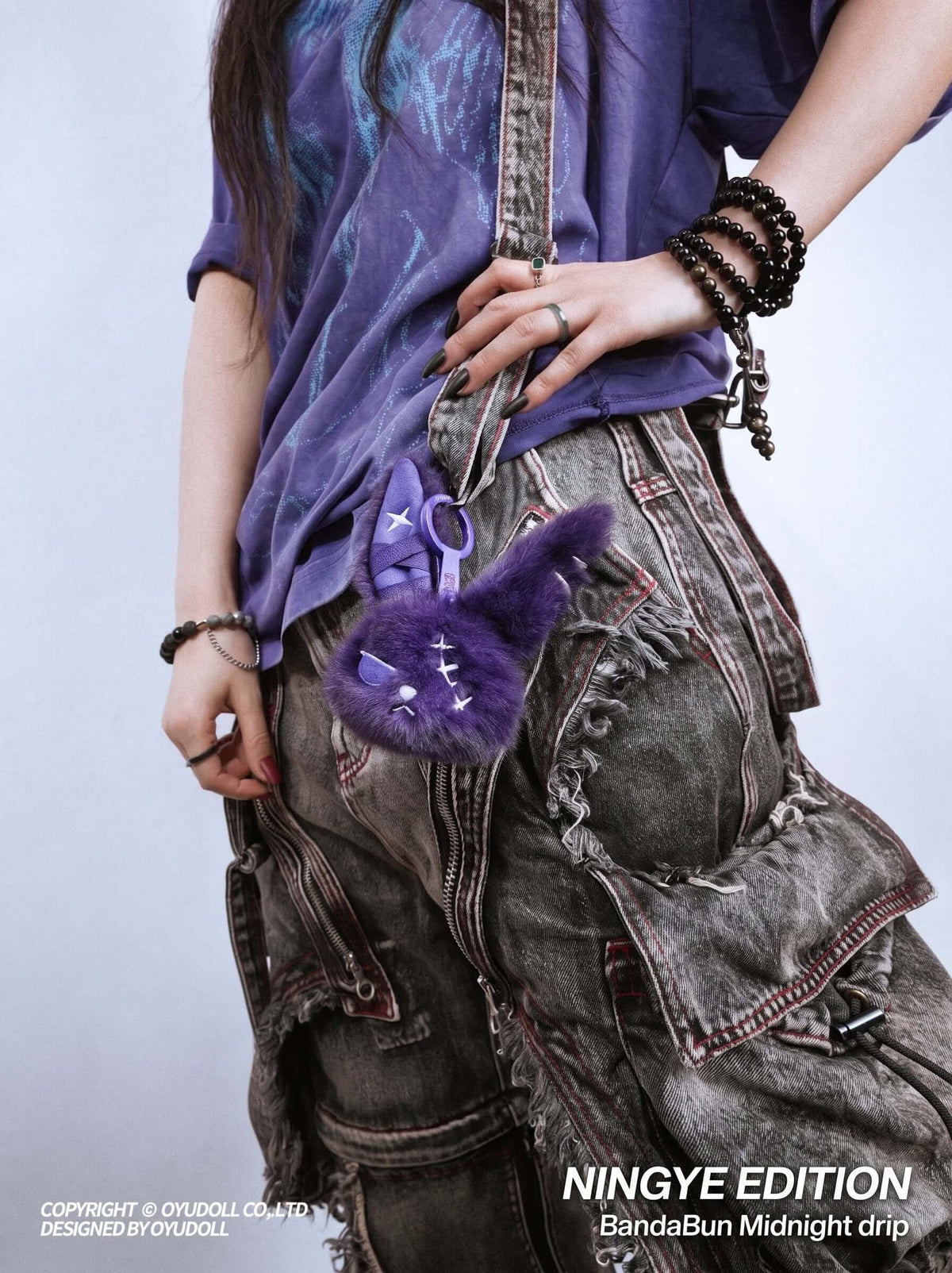 Cuddly Bunny - DarkCute BandaBun hanging on stylish outfit, showcasing its adorable design and premium plush texture.