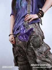 Cuddly Bunny - DarkCute BandaBun hanging on stylish outfit, showcasing its adorable design and premium plush texture.