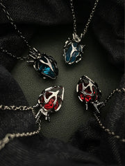 Soul Resonance Gothic Heart Necklace showcasing four vintage gothic hearts with red and blue glass cores.