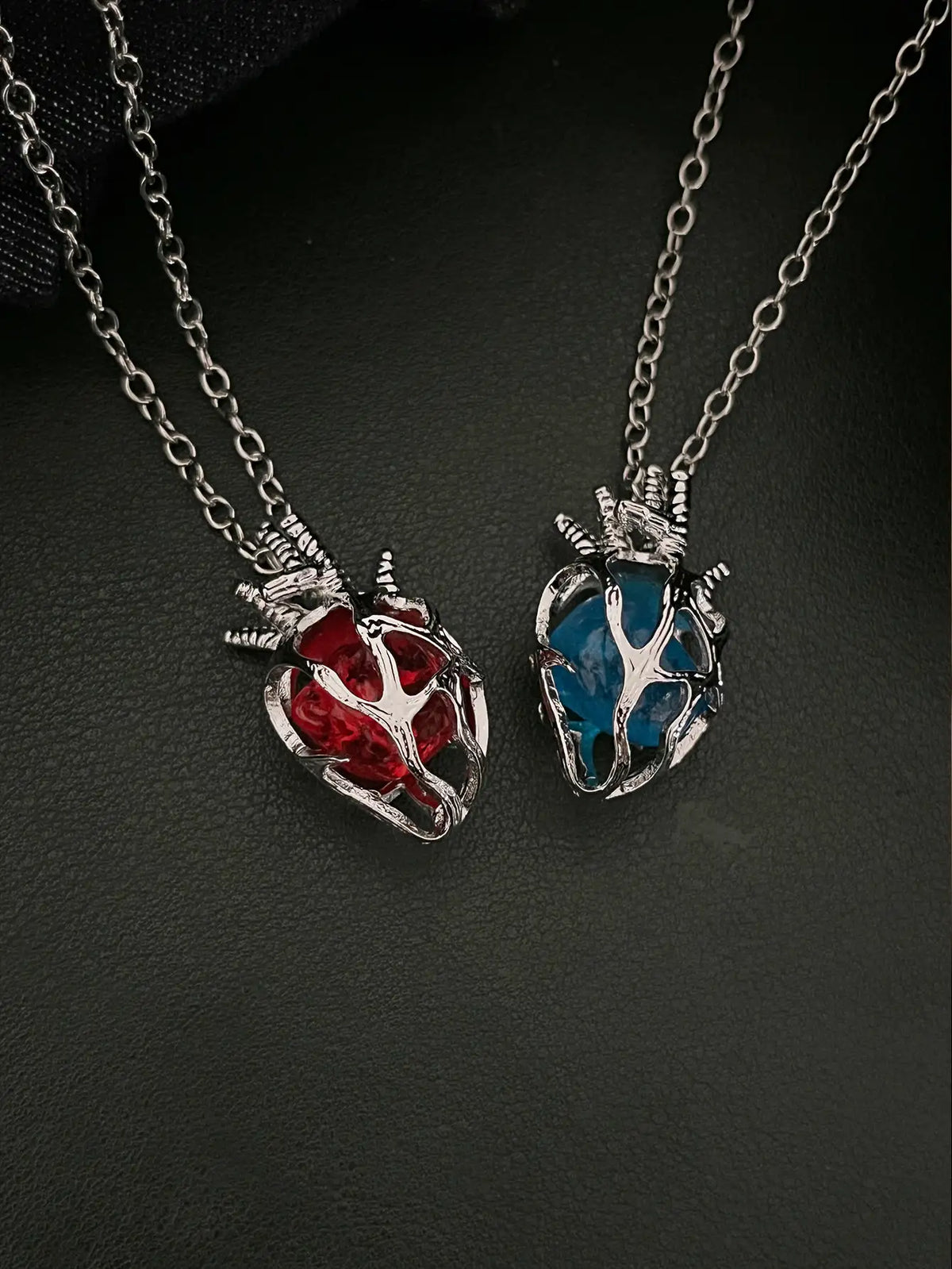 Soul Resonance Gothic Heart Necklace featuring red and blue glass hearts in vintage-gothic style.