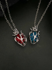 Soul Resonance Gothic Heart Necklace featuring red and blue glass hearts in vintage-gothic style.