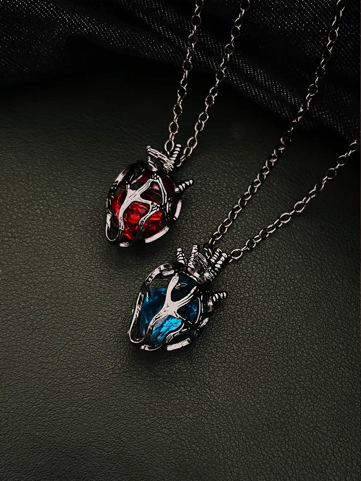 Soul Resonance Gothic Heart Necklace featuring red and blue glass hearts in vintage gothic filigree design.