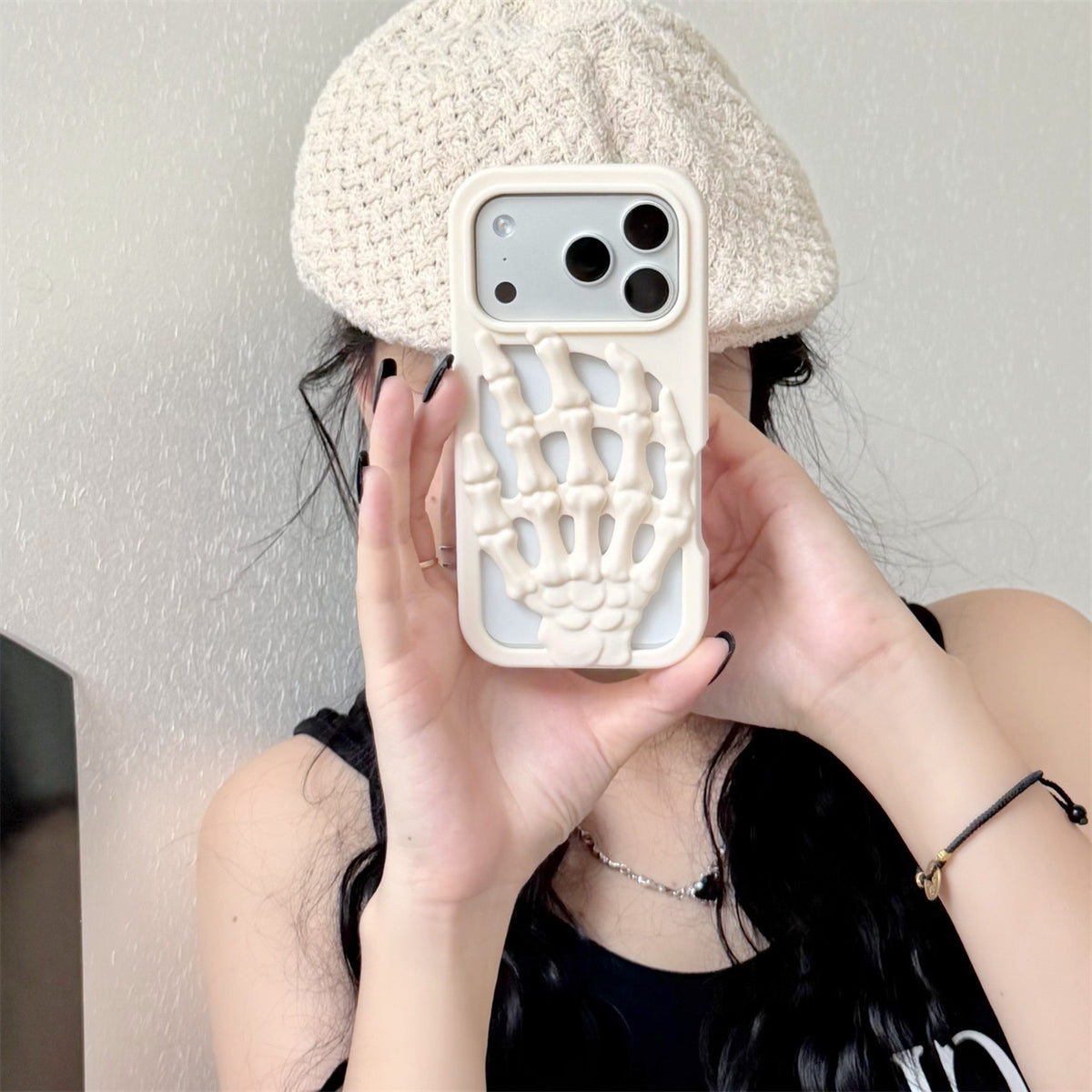 3D Skeleton Hand Gothic Phone Cover displayed on a person's hand, featuring a sculpted skeletal hand design for stylish protection.