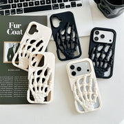 3D Skeleton Hand Gothic Phone Cover displayed on a desk with a laptop and magazine.