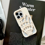 3D Skeleton Hand Gothic Phone Cover displayed on a magazine, featuring a sculpted skeletal hand design.