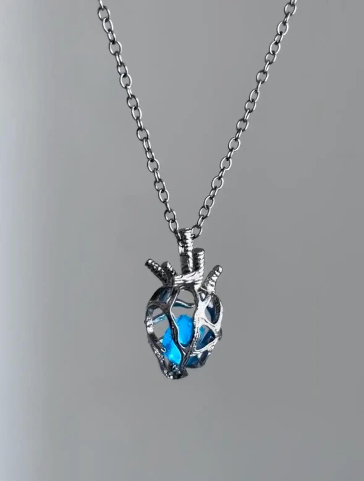 Soul Resonance Gothic Heart Necklace featuring a blue glass heart in vintage-gothic filigree design.
