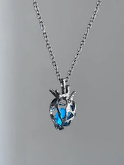Soul Resonance Gothic Heart Necklace featuring a blue glass heart in vintage-gothic filigree design.