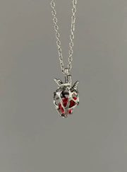 Soul Resonance Gothic Heart Necklace featuring silver filigree heart with red glass core on a delicate chain.