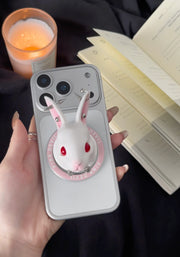 Angry Bunny MagSafe Phone Stand displayed on smartphone with candle and notepad in background.