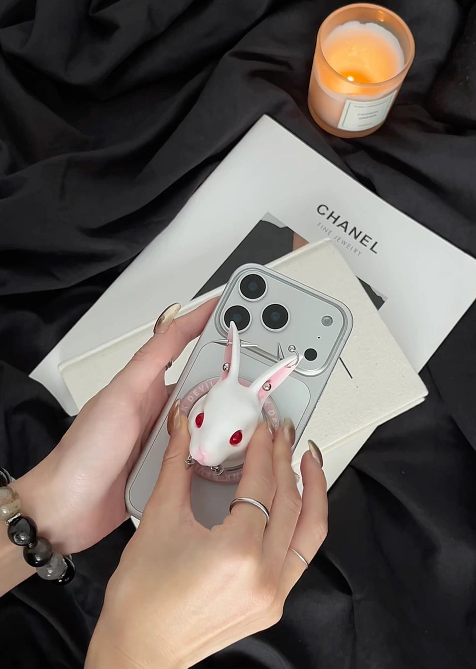 Angry Bunny MagSafe Phone Stand on a smartphone, showcasing its stylish wax-white rabbit design and hands-free functionality.