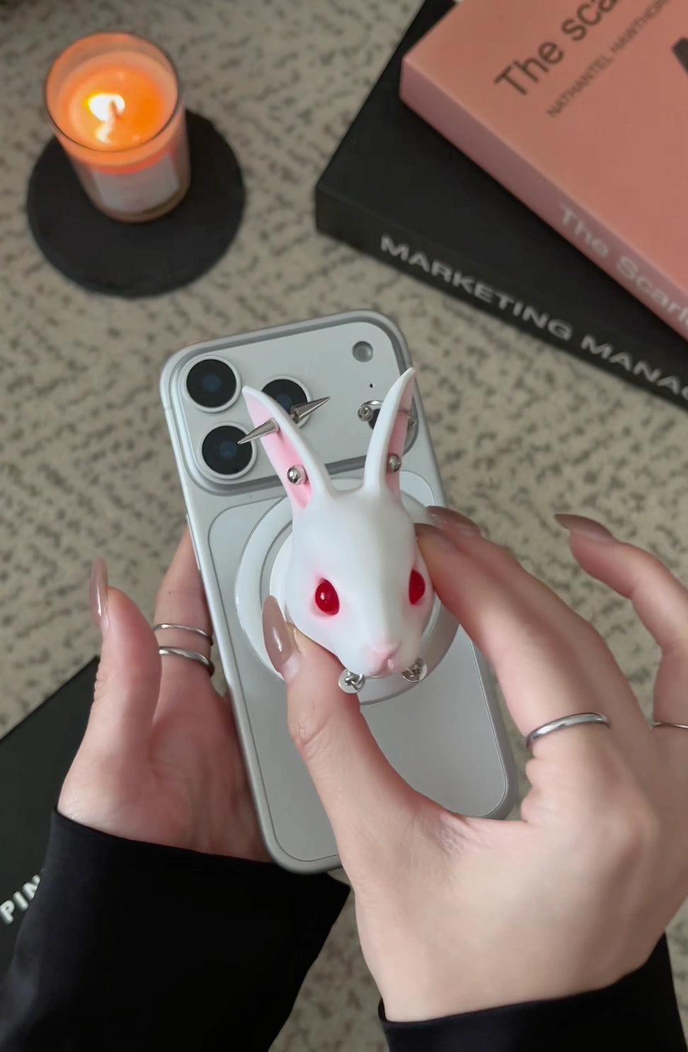 Angry Bunny MagSafe Phone Stand on a smartphone, held by a person with stylish nails, showcasing its unique design.