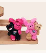 Cat Bunny Hugging Plush Charm featuring a cat and bunny plush keychain on a wooden shelf.