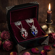 Soul Resonance Gothic Heart Necklace in a vintage box with a red and blue heart pendant.