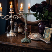Soul Resonance Gothic Heart Necklace displayed on a vintage stand with candles and dark roses.