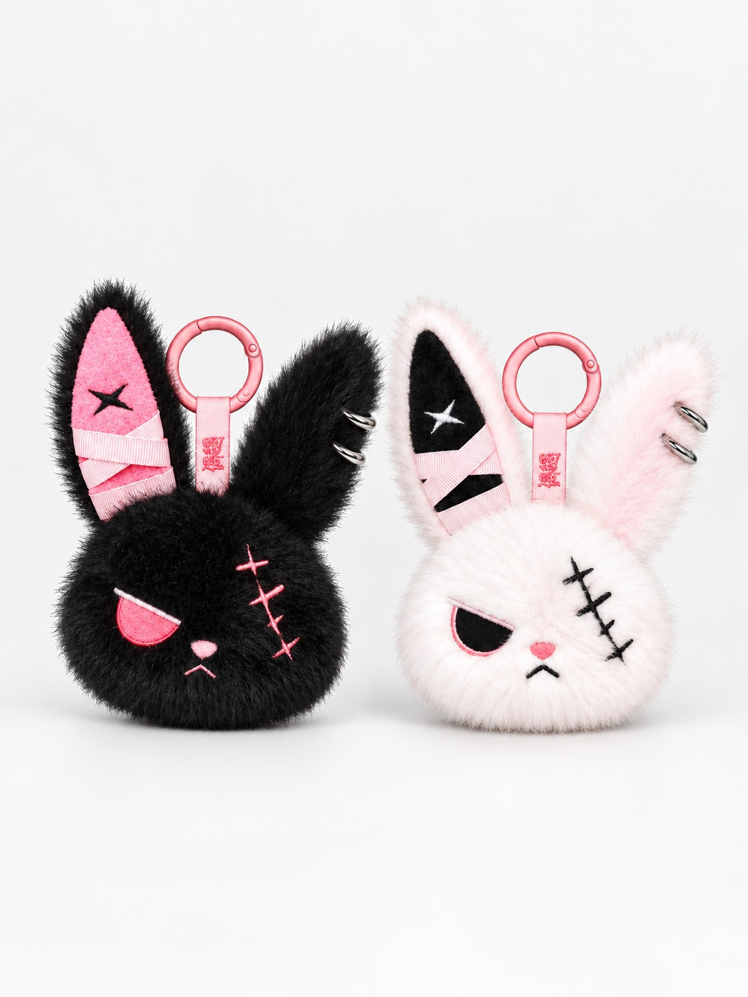 Cuddly bunny plush keychain in black and pink, featuring cute designs with distinctive stitched details.