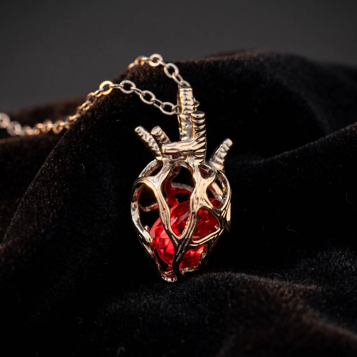 Soul Resonance Gothic Heart Necklace featuring a vintage silver heart design with a red glass core.