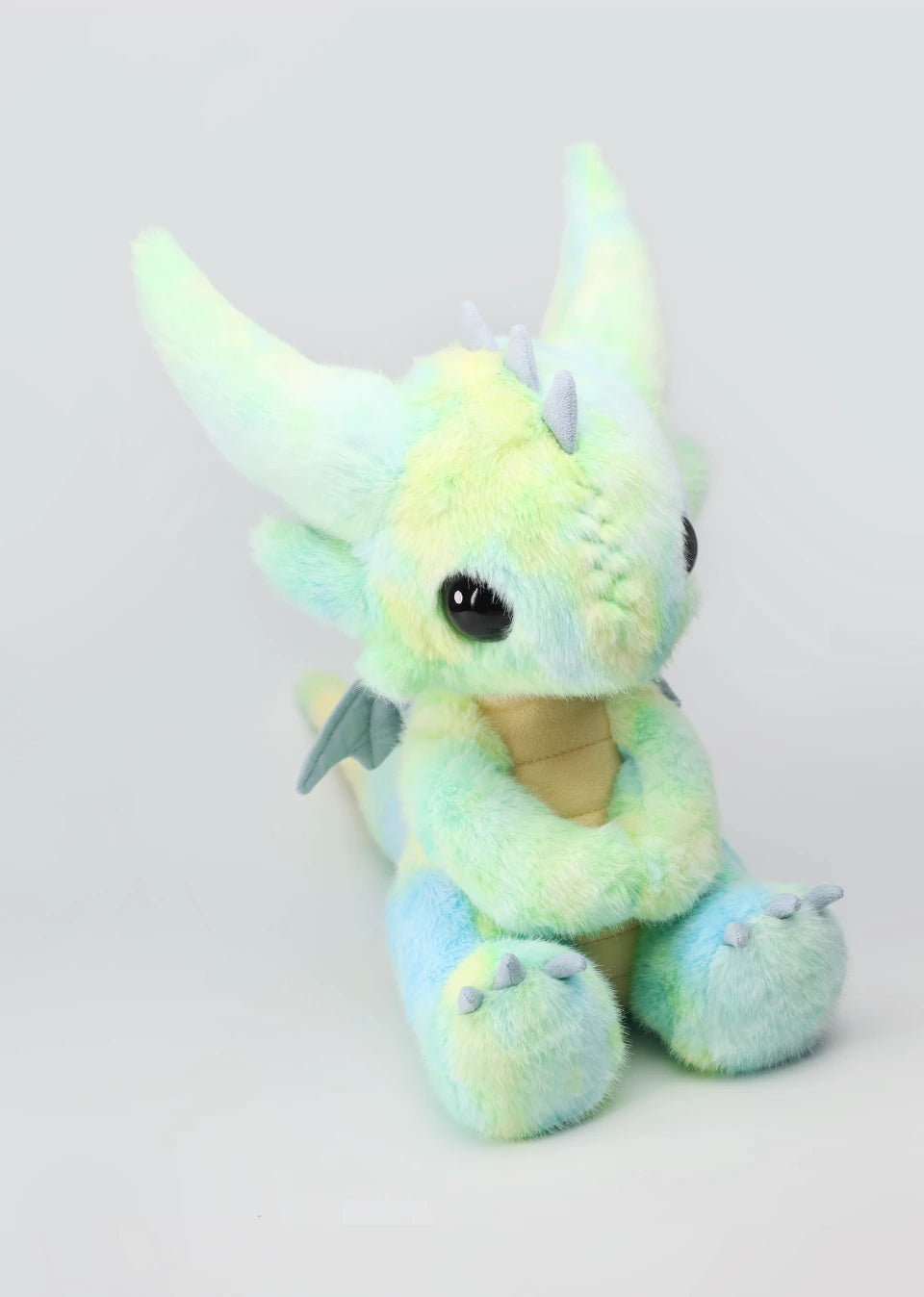 Stuffed dragon Boo in pastel colors, a limited edition plush toy perfect for cuddling and display.