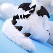 Close-up of the tail and wings of a stuffed dragon, part of the limited edition collection.