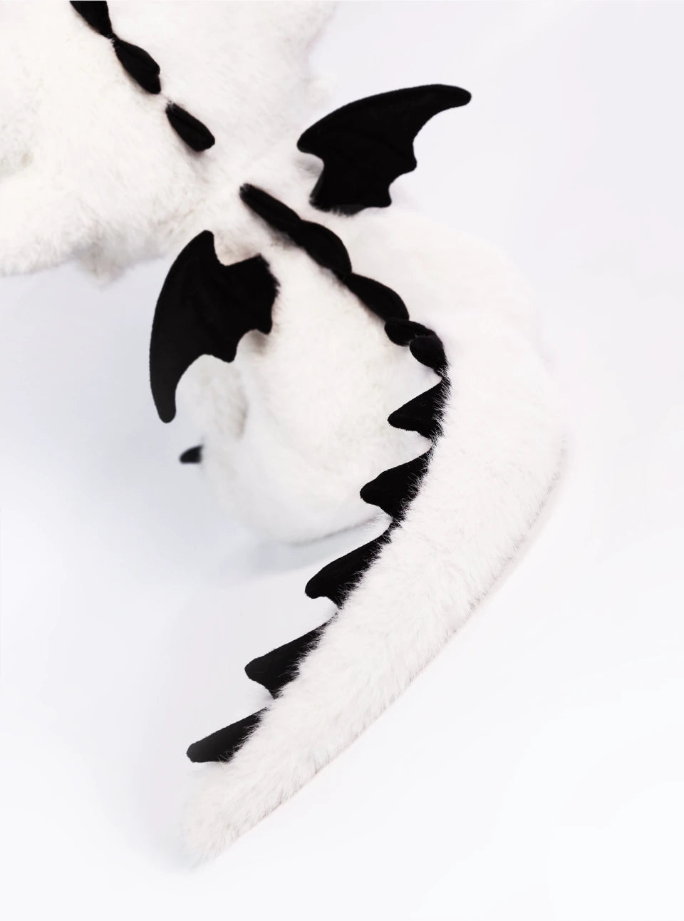 Stuffed dragon Boo plush tail with black wings and spine details, showcasing the limited edition design.