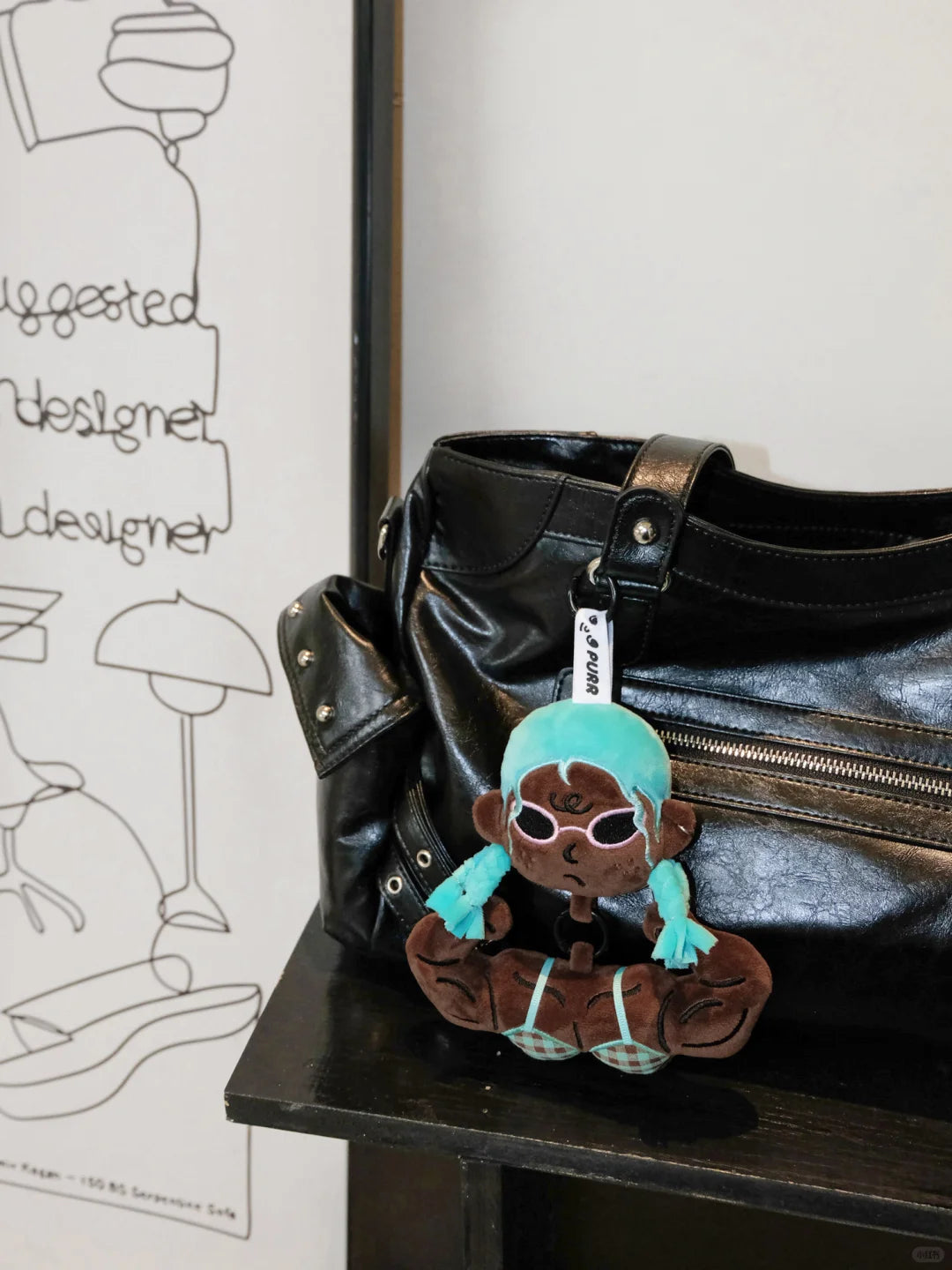 Buu Evil Plush Bag Charm attached to a black bag, showcasing its playful design and muscular features.