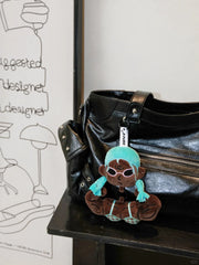 Buu Evil Plush Bag Charm attached to a black bag, showcasing its playful design and muscular features.