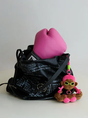 Buu Evil plush bag charm hanging from a black gym bag with a pink boxing glove inside, perfect for gym lovers.