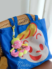Buu Evil Plush Bag Charm attached to a blue tote bag with a Mister Donut design.