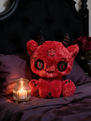 Dark Envoy Reaper Plush - Buu Evil sitting on a bed with a candle, featuring red plush design and cute details.