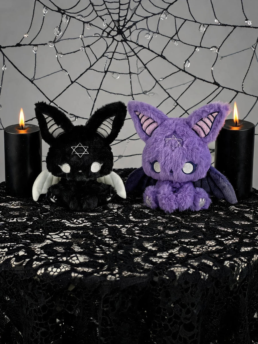 Dark Envoy Gothic Cute Plush Doll - Buu Evil duo featuring a black and purple variant on a gothic-themed table with candles.