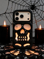 Buu Evil:Gothic punk skull studded iPhone case displayed with candles and spiderweb decor.