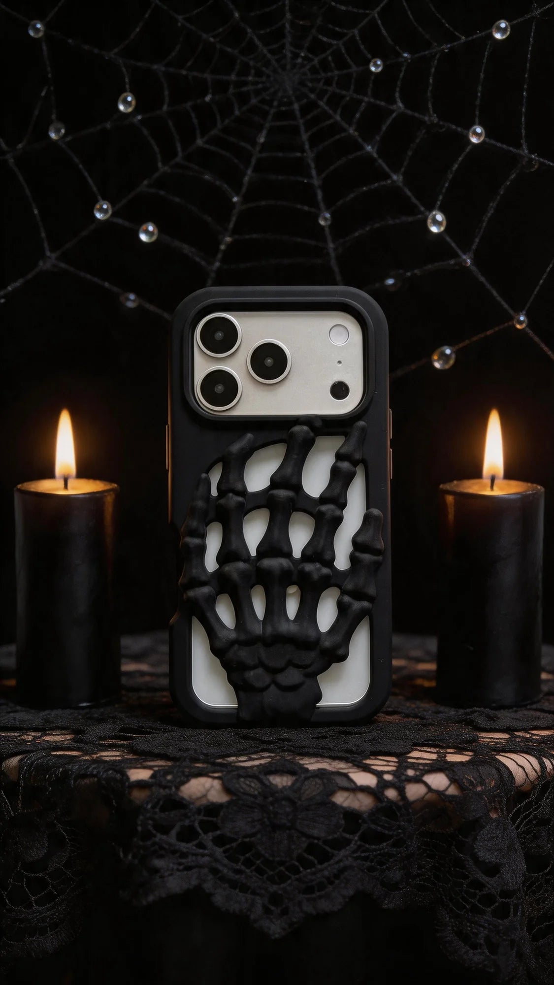 3D Skeleton Hand Gothic Phone Cover displayed with candles and a spiderweb backdrop, showcasing its unique design and gothic style.