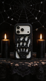 3D Skeleton Hand Gothic Phone Cover displayed with candles and a spiderweb backdrop, showcasing its unique design and gothic style.