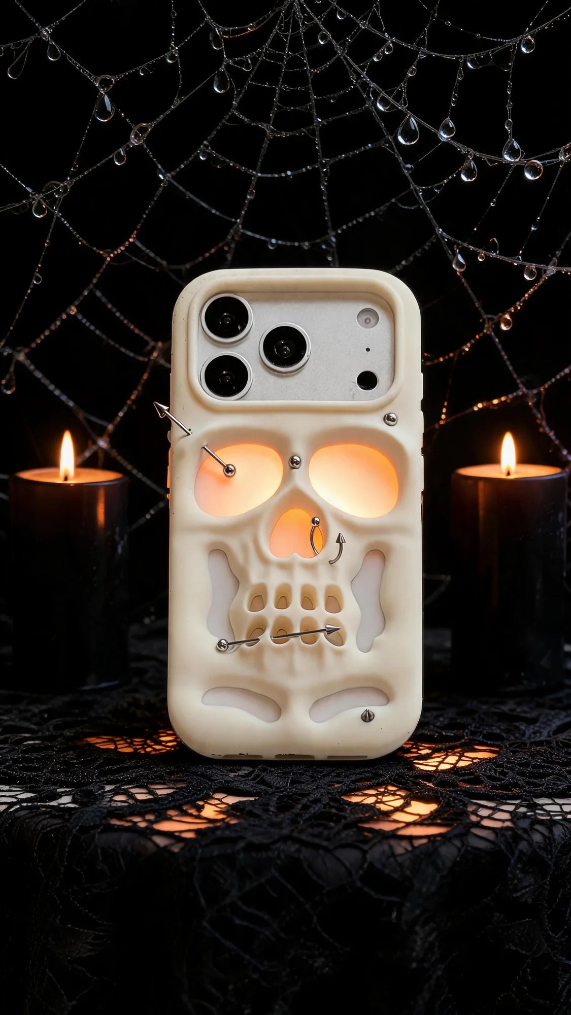 Buu Evil:Gothic punk skull studded iPhone case surrounded by candles and spiderwebs, showcasing its unique hollow skull design.