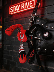 Rivet Punk Rabbit plush charm with spikes and red-black design hanging from a stylish bag in urban setting.
