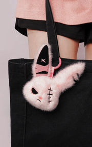 Cuddly Bunny - DarkCute BandaBun plush accessory attached to a stylish black tote bag.